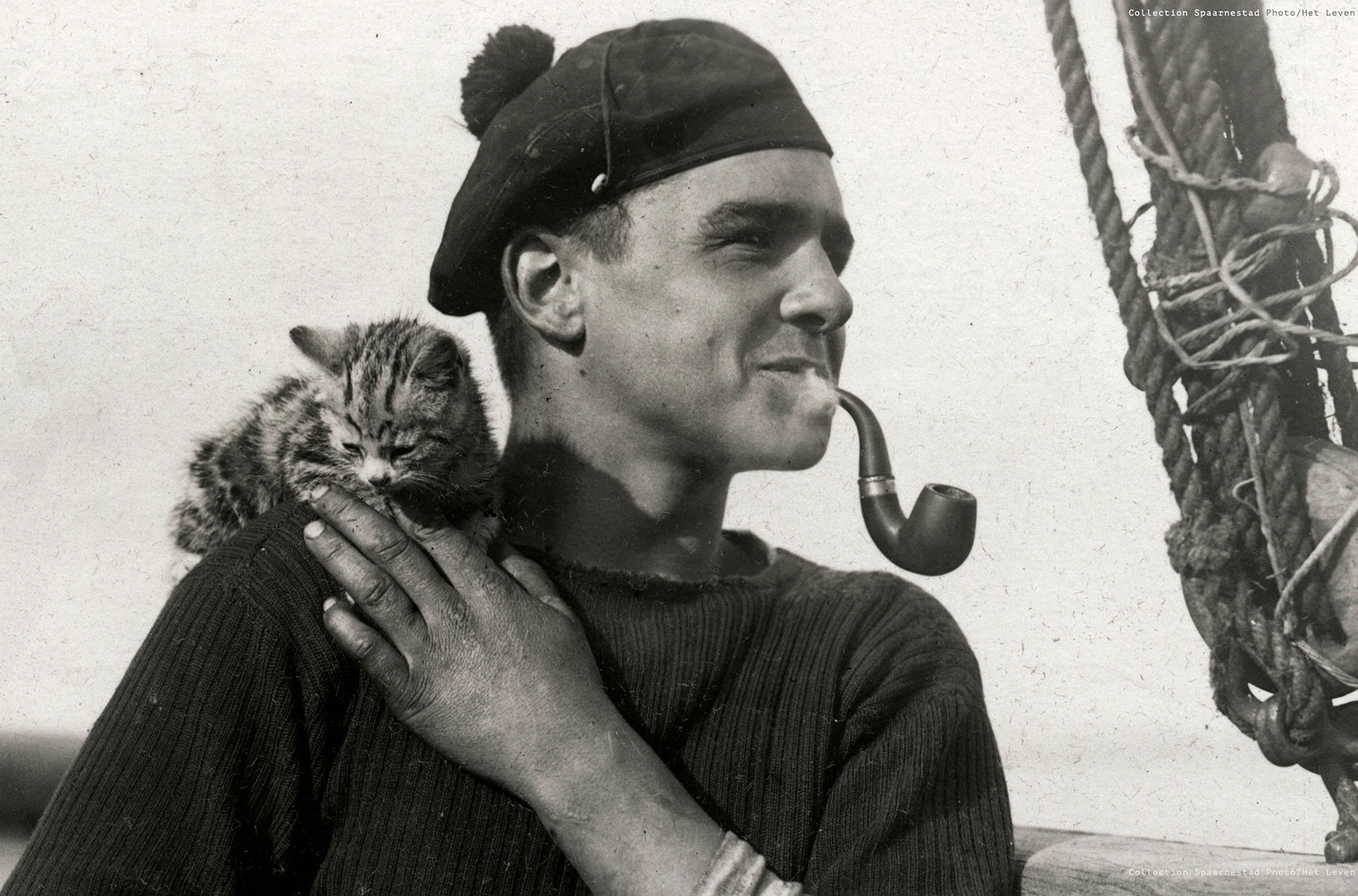Sailor holding cat smoking pipe