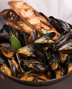 Hands holding a bowl of Mussels